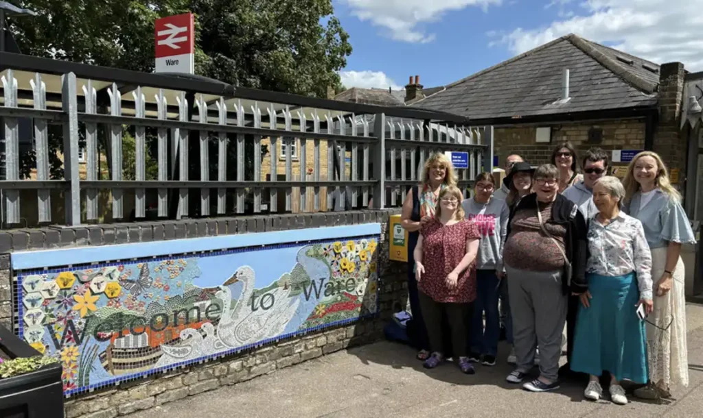 The mosaic with Jo Radcliffe (far left), Donna Reeves (far right), Katie Goldthorpe (back with sunglasses) and charity members